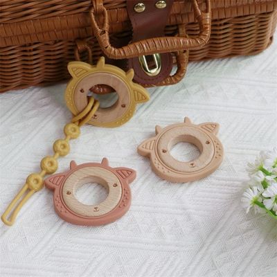 Multifunktionales Silikon-Babytandhalter mit zersetzbarem Zahnring aus Holz